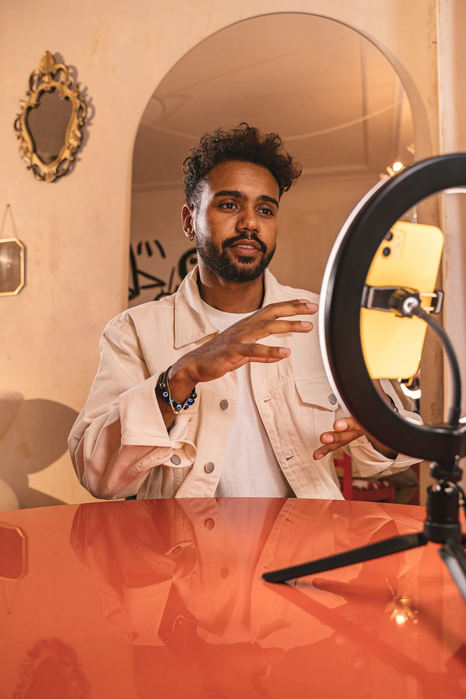 A man records a video in front of a ring light